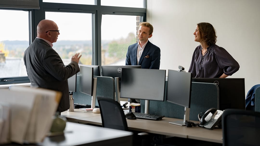 Davif Tidswell, Ben Aris and Miriam Wilson talking in the office