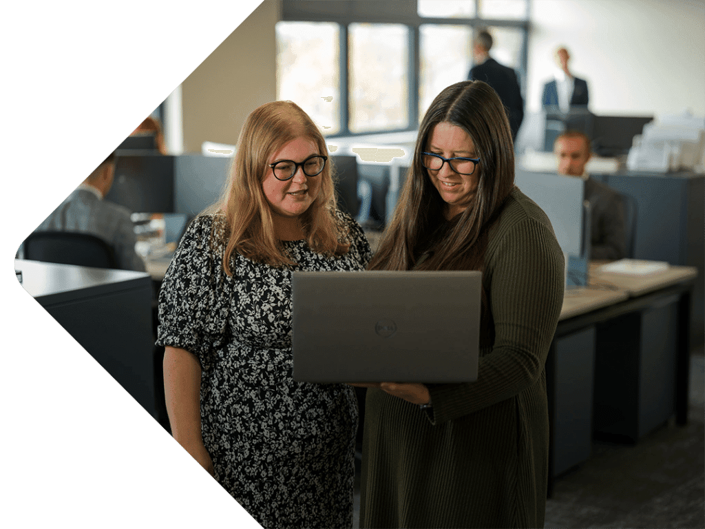 Charlotte Owen and claire pass working on a laptop